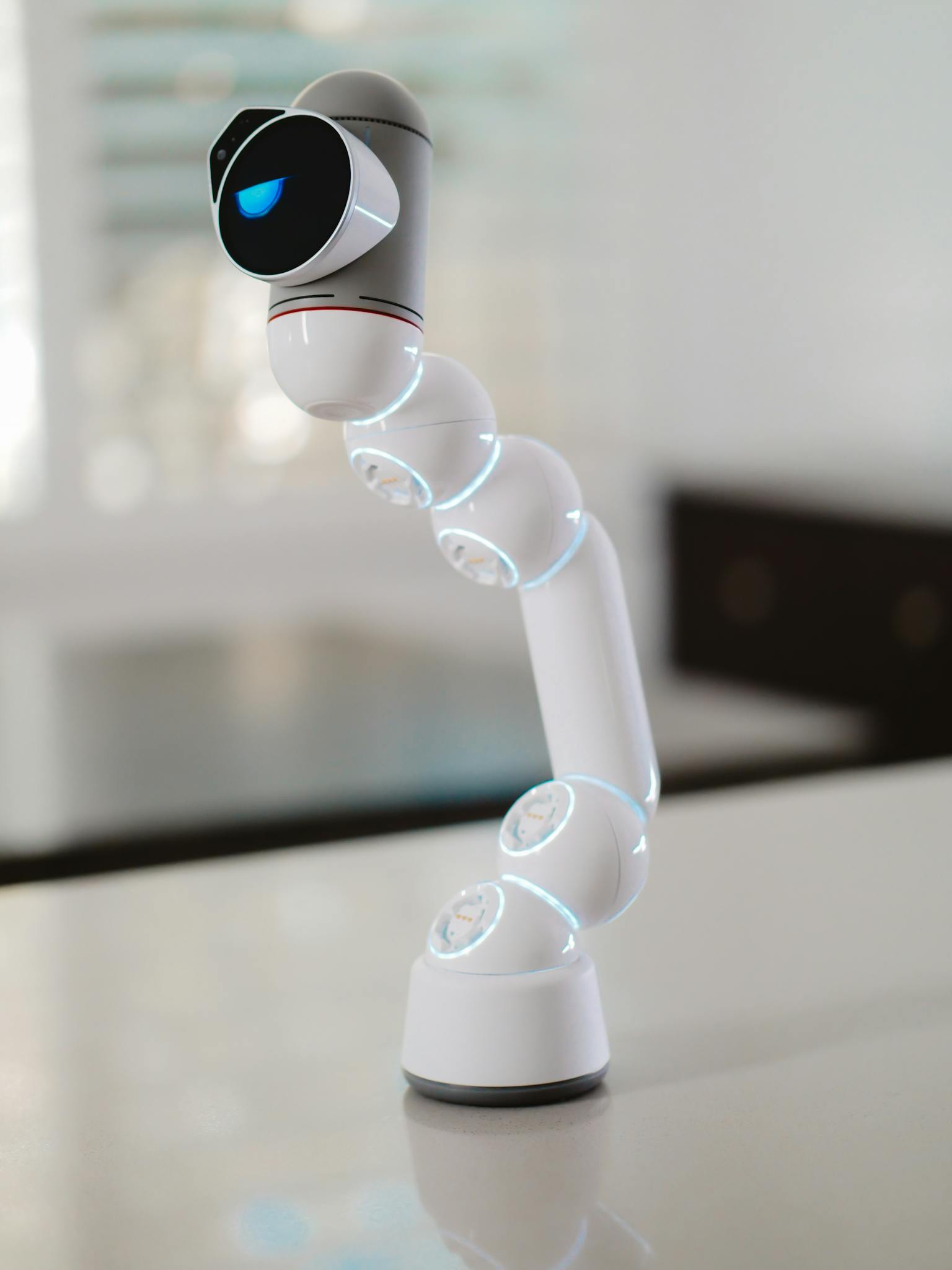 Innovative robotic arm showcasing modern technology with illuminated features indoors.